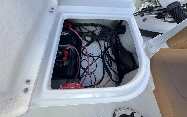 Slide: The Image of Battery compartment of 2025 Clearwater 2200 boat with wiring and connections. - 17