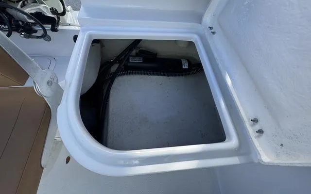 Slide: The Image of Open storage compartment in a 2025 Clearwater 2200 boat. - 21