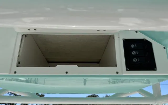 Slide: The Image of Clearwater 2200 boat console with open compartment and control panel, 2025 model. - 22