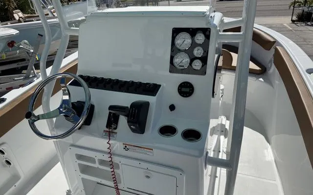 Slide: The Image of 2025 Clearwater 2200 boat console with steering wheel and gauges. - 23