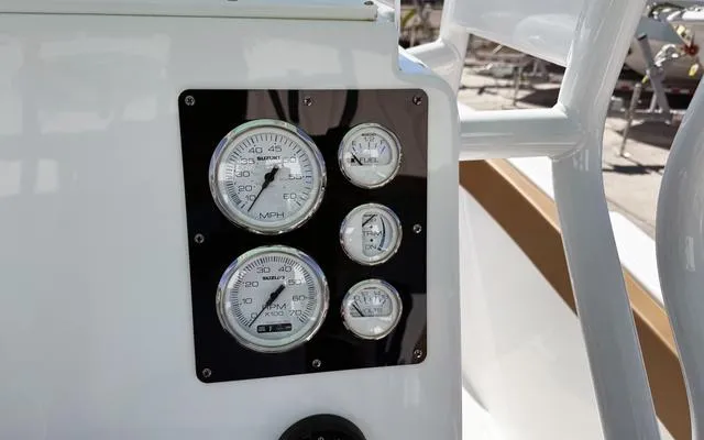 Slide: The Image of Dashboard gauges on a 2025 Clearwater 2200 boat. - 25