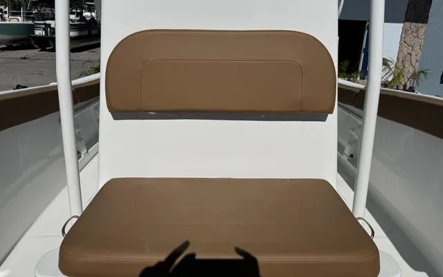 Slide: The Image of Brown cushioned seat on a 2025 Clearwater 2200 boat, outdoor setting. - 27