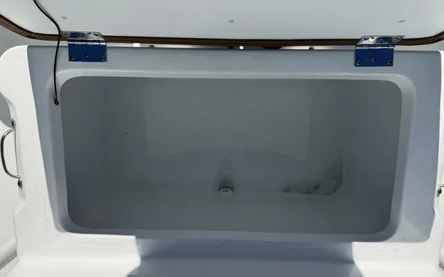 Slide: The Image of Open storage compartment on a 2025 Clearwater 2200 boat. - 28