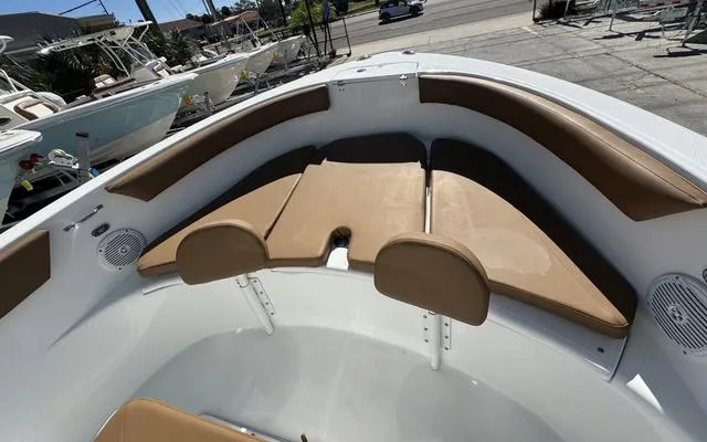 Slide: The Image of Interior of 2025 Clearwater 2200 boat with tan cushioned seating. - 29