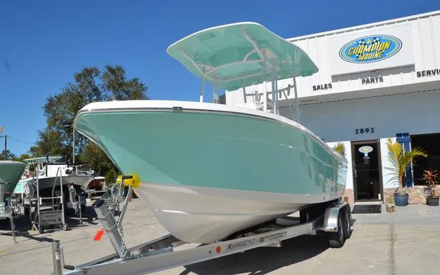 Slide: The Image of 2025 Clearwater 2200 boat on trailer outside marine dealership. - 3