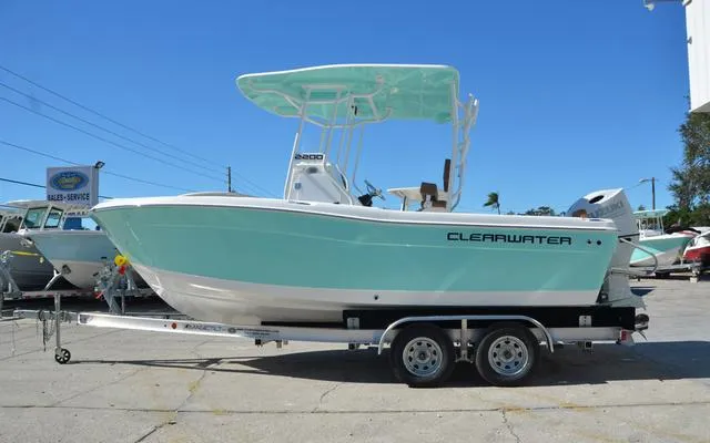 Slide: The Image of 2025 Clearwater 2200 boat on trailer, mint green hull, outdoor dealership setting. - 4