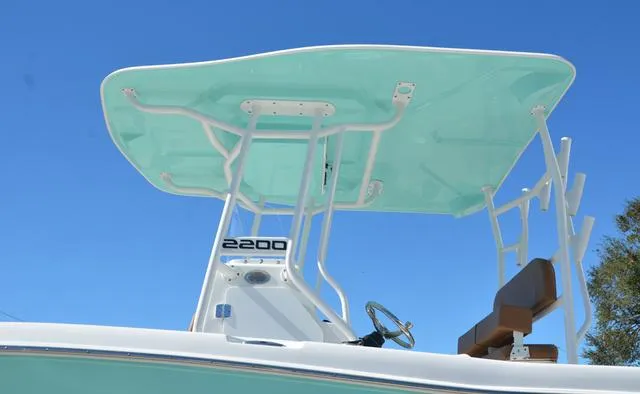 Slide: The Image of Clearwater 2200 boat, 2025 model, featuring a sleek T-top design against a clear blue sky. - 5