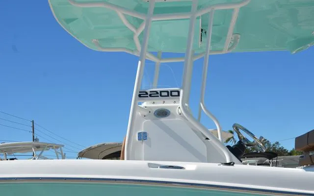 Slide: The Image of Clearwater 2200 boat, 2025 model, featuring a sleek design and modern console against a clear blue sky. - 6