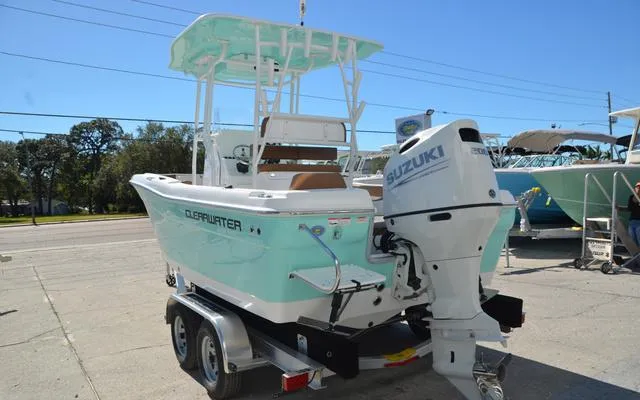Slide: The Image of 2025 Clearwater 2200 boat with Suzuki outboard motor on trailer, parked outdoors. - 8