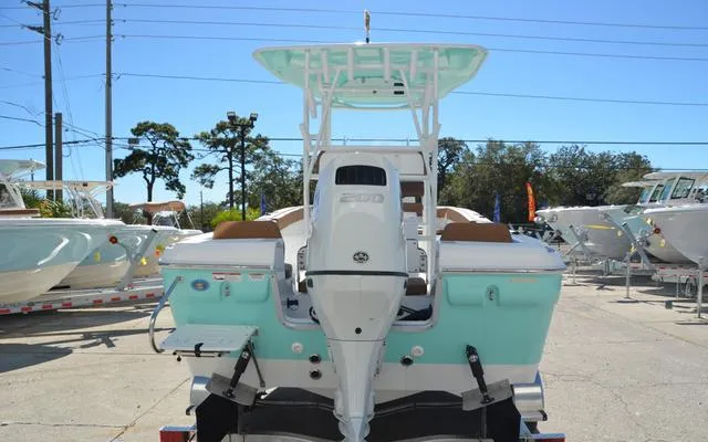 Slide: The Image of 2025 Clearwater 2200 boat with outboard motor, displayed outdoors in a marina setting. - 9