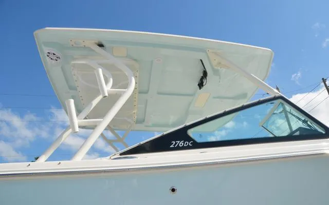 Slide: The Image of 2025 Sailfish 276 DC boat with sleek design and modern features under a clear blue sky. - 12