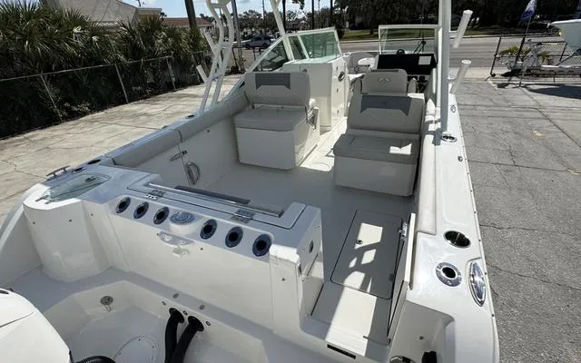 Slide: The Image of 2025 Sailfish 276 DC boat interior with seating and fishing rod holders. - 13