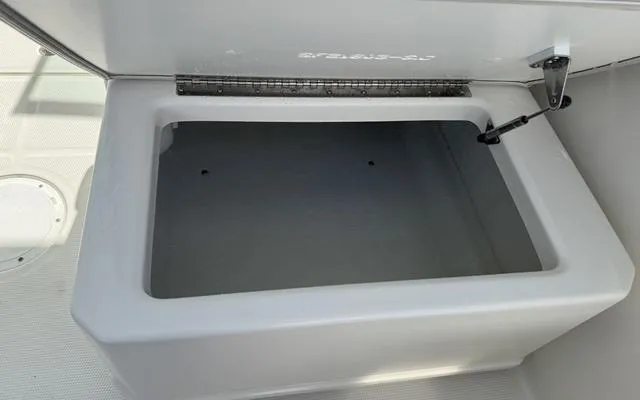 Slide: The Image of 2025 Sailfish 276 DC storage compartment, open lid, spacious interior. - 19