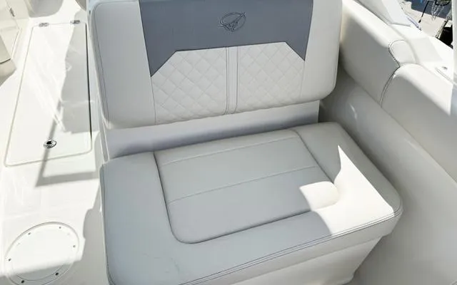 Slide: The Image of 2025 Sailfish 276 DC boat seat with quilted upholstery and logo detail. - 20