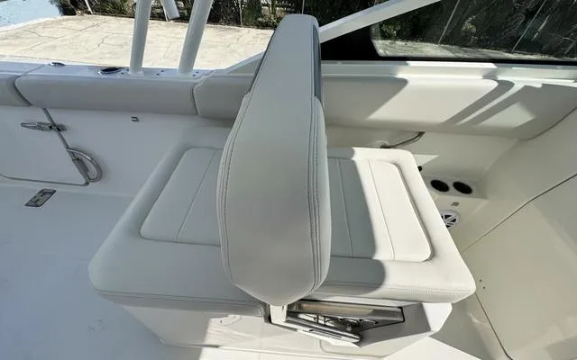 Slide: The Image of 2025 Sailfish 276 DC boat interior with white cushioned seating. - 21