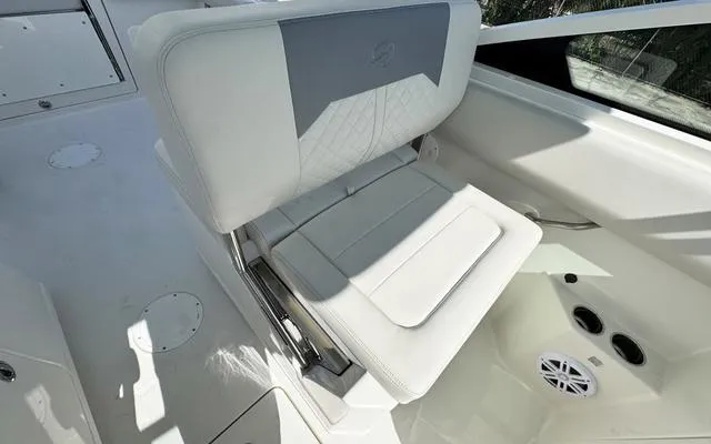 Slide: The Image of 2025 Sailfish 276 DC boat seat, white upholstery, modern design, interior view. - 22