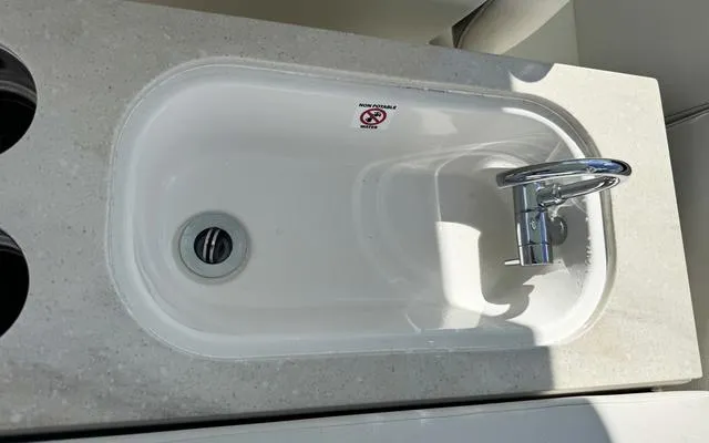 Slide: The Image of 2025 Sailfish 276 DC boat sink with modern faucet and countertop. - 24