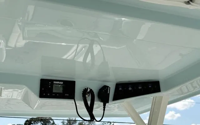 Slide: The Image of 2025 Sailfish 276 DC boat dashboard with Simrad electronics and communication equipment. - 28