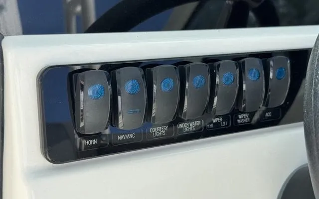 Slide: The Image of Control panel of 2025 Sailfish 276 DC boat with labeled switches for various functions. - 30