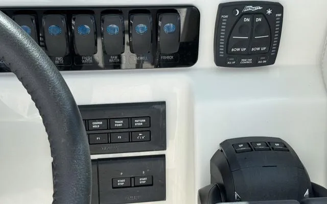 Slide: The Image of Control panel of 2025 Sailfish 276 DC boat with switches and steering wheel. - 31