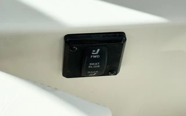 Slide: The Image of 2025 Sailfish 276 DC seat slide control switch on white panel. - 35