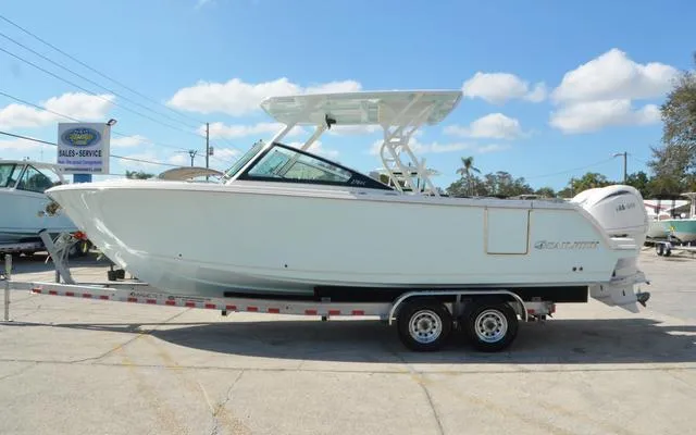 Slide: The Image of 2025 Sailfish 276 DC boat on trailer under clear blue sky. - 4