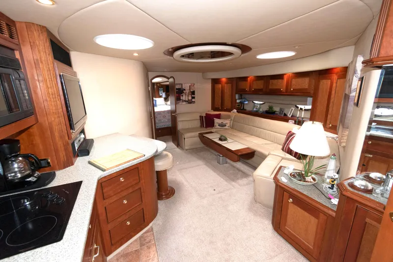 Slide: The Image of Luxurious interior of 2003 Cruisers Yachts 5370 Express with elegant wood cabinetry and plush seating. - 10