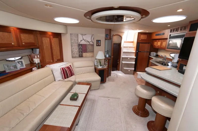 Slide: The Image of Luxurious interior of 2003 Cruisers Yachts 5370 Express with elegant seating and modern kitchen. - 14
