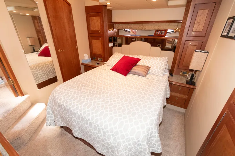 Slide: The Image of Luxurious bedroom interior of 2003 Cruisers Yachts 5370 Express with elegant bedding and wood accents. - 16