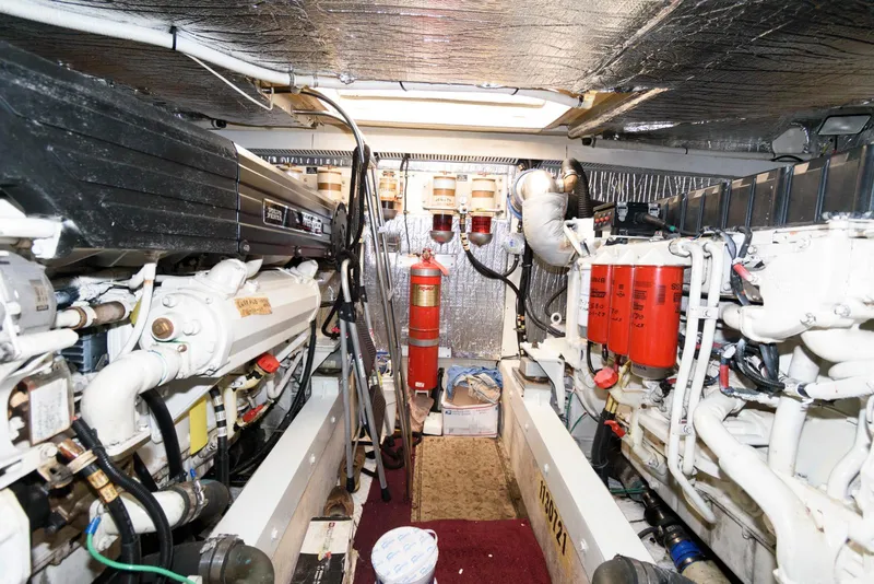 Slide: The Image of Engine room of 2003 Cruisers Yachts 5370 Express, featuring dual engines and fire suppression system. - 22