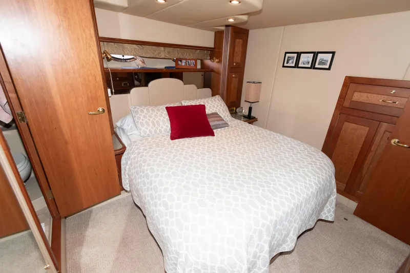 Slide: The Image of Luxurious bedroom interior of 2003 Cruisers Yachts 5370 Express with cozy bed and wooden accents. - 15