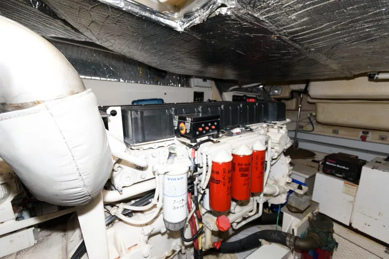 Slide: The Image of Engine room of 2003 Cruisers Yachts 5370 Express with visible machinery and components. - 23