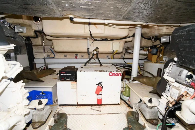 Slide: The Image of Engine room of 2003 Cruisers Yachts 5370 Express with Onan generator and equipment. - 25