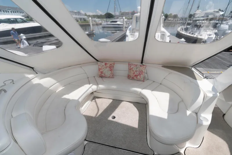 Slide: The Image of Luxurious 2003 Cruisers Yachts 5370 Express interior with plush seating and marina view. - 4