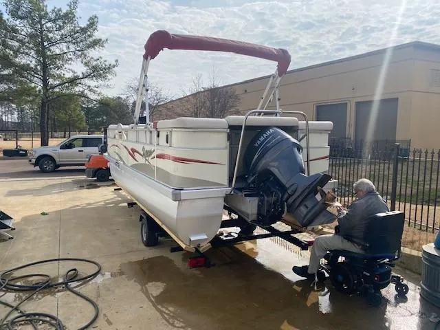 Slide: The Image of 2008 Voyager Pontoons 22 Sport Cruise on trailer, with Yamaha outboard motor, parked outdoors. - 3