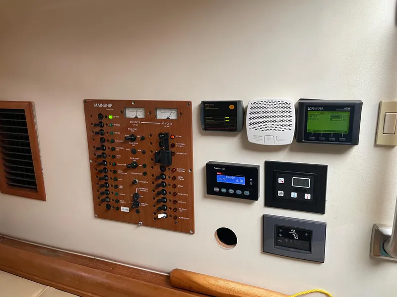 Slide: The Image of Control panel of a 2006 Mainship Pilot 34 boat with various electronic displays. - 16