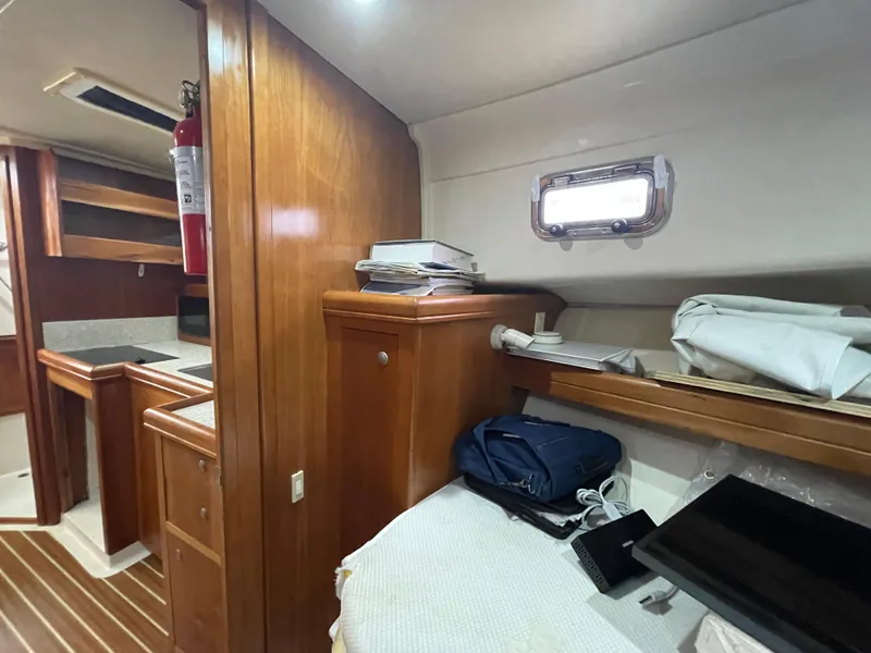 Slide: The Image of Interior of 2006 Mainship Pilot 34 boat with wooden cabinetry and compact living space. - 23