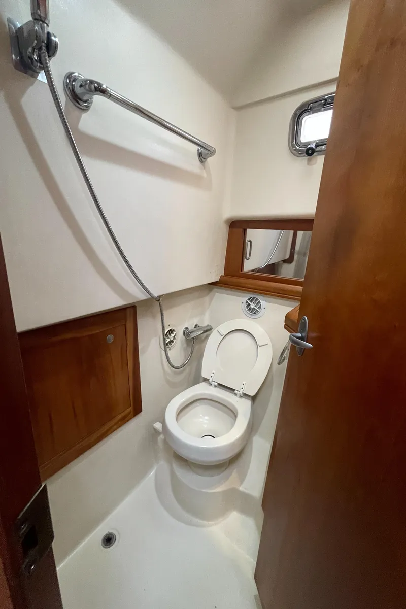 Slide: The Image of 2006 Mainship Pilot 34 boat bathroom with shower and toilet. - 29
