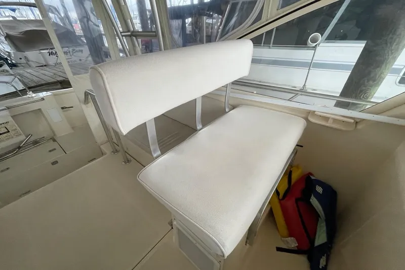 Slide: The Image of 2006 Mainship Pilot 34 boat interior with white cushioned seating and visible life jackets. - 35