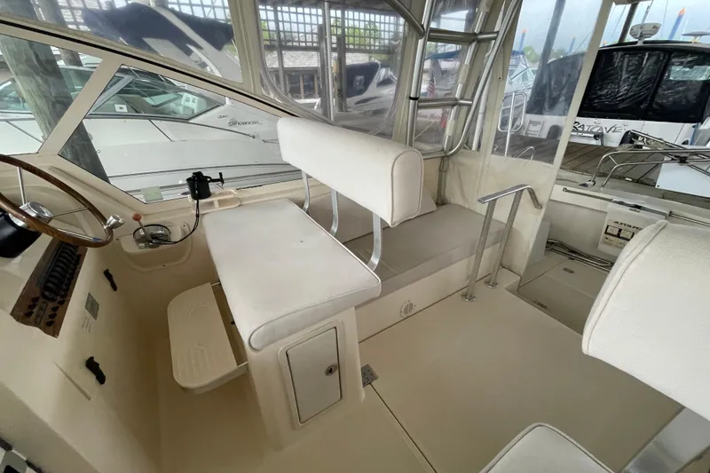 Slide: The Image of 2006 Mainship Pilot 34 interior with helm station and seating area. - 36