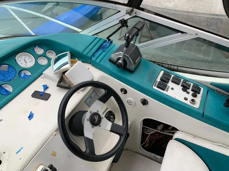 Slide: The Image of 1995 Silverton 310 Express boat dashboard with steering wheel and control panel. - 5