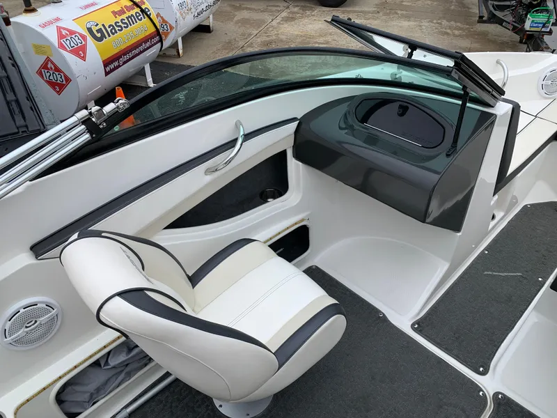 Slide: The Image of 2013 Sea Ray 190 Sport boat interior with white seating and dashboard. - 3