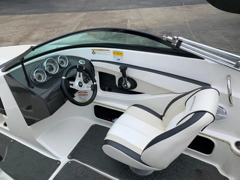 Slide: The Image of 2013 Sea Ray 190 Sport boat interior with steering wheel and gauges. - 4