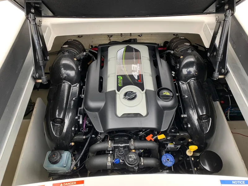 Slide: The Image of Engine compartment of a 2013 Sea Ray 190 Sport boat, showcasing a powerful engine. - 6