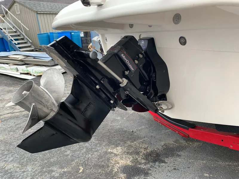Slide: The Image of 2013 Sea Ray 190 Sport boat with MerCruiser outdrive, parked on a trailer. - 7