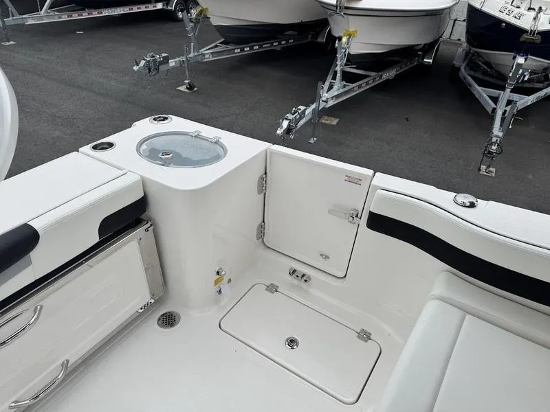Slide: The Image of 2025 Robalo R 257 boat interior with storage compartments and seating. - 3