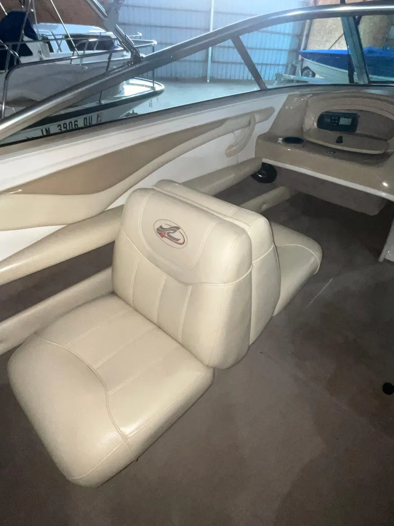 Slide: The Image of 2000 Sea Ray 185 Bow Rider interior with beige seating and dashboard. - 14