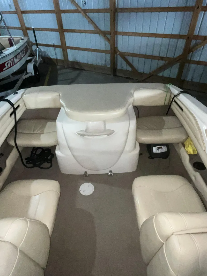 Slide: The Image of 2000 Sea Ray 185 Bow Rider interior with beige seating in storage. - 15