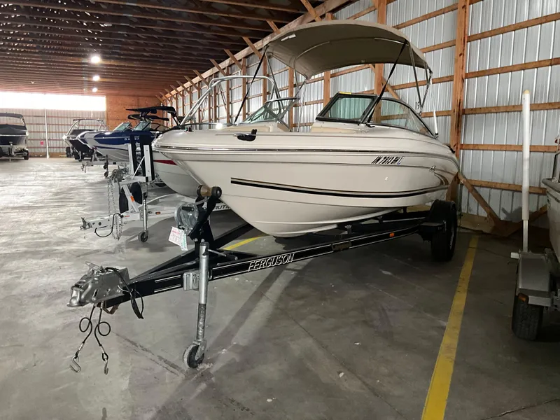 Slide: The Image of 2000 Sea Ray 185 Bow Rider boat on trailer in storage facility. - 2