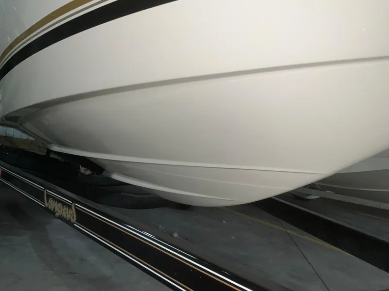 Slide: The Image of 2000 Sea Ray 185 Bow Rider boat hull on trailer, close-up view. - 4